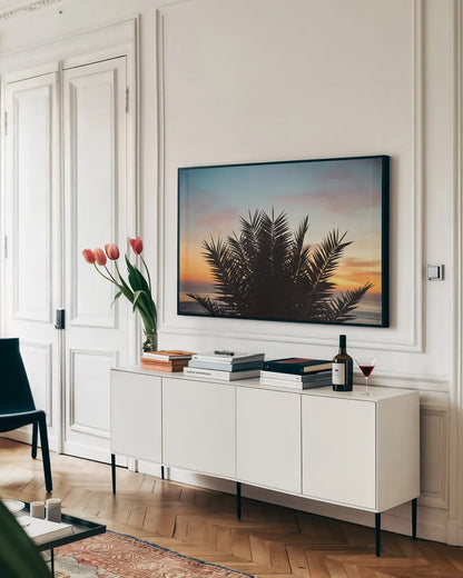 Sunset Palms II by Laura Marshall. shown as a framed stretched canvas in a living room above a console. Available as a archival giclee rolled canvas, fine art paper, or poster print. SKU 42852i.