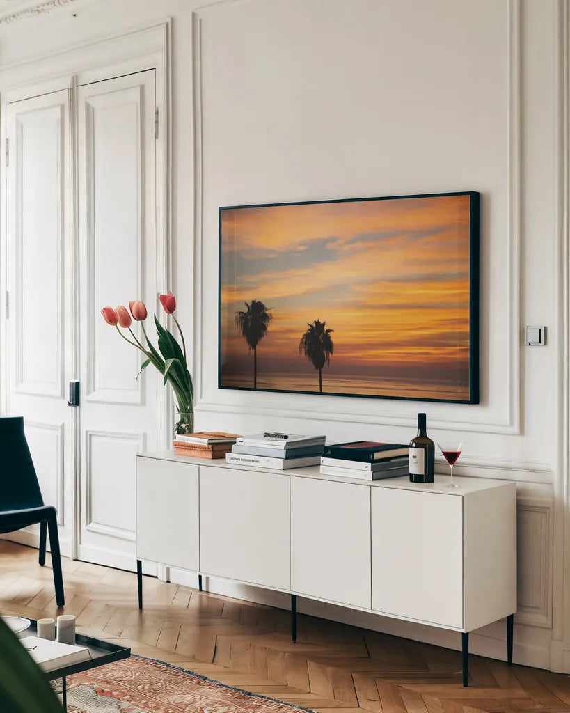 Sunset Palms III by Laura Marshall. shown as a framed stretched canvas in a living room above a console. Available as a archival giclee rolled canvas, fine art paper, or poster print. SKU 42853i.