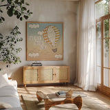 Up Up and Away Adventure by Laura Marshall. Shown in a natural wood frame in a cozy modern living room. Available as an archival giclee rolled canvas, fine art paper, or poster print. SKU 18458a.
