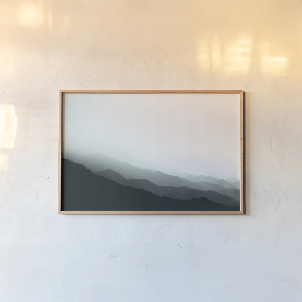 Virgin Mountains II Blue Gray by Laura Marshall. shown as a paper print in a natural frame. Available as a archival giclee rolled canvas, fine art paper, or poster print. SKU 79233i.