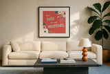 Wildflower Daydreams V Move Mountains Red by Laura Marshall. Displayed in a glass frame with matte in a clean modern living room. Available as an archival giclee rolled canvas, fine art paper, or poster print. SKU 35506a.