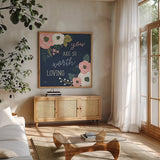 Wildflower Daydreams VII Navy Loving by Laura Marshall. Shown in a natural wood frame in a cozy modern living room. Available as an archival giclee rolled canvas, fine art paper, or poster print. SKU 36381a.