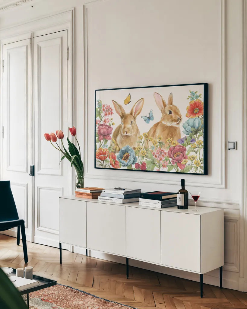 Garden Bunnies I by Leslie Trimbach. shown as a framed stretched canvas in a living room above a console. Available as a archival giclee rolled canvas, fine art paper, or poster print. SKU 83601i.