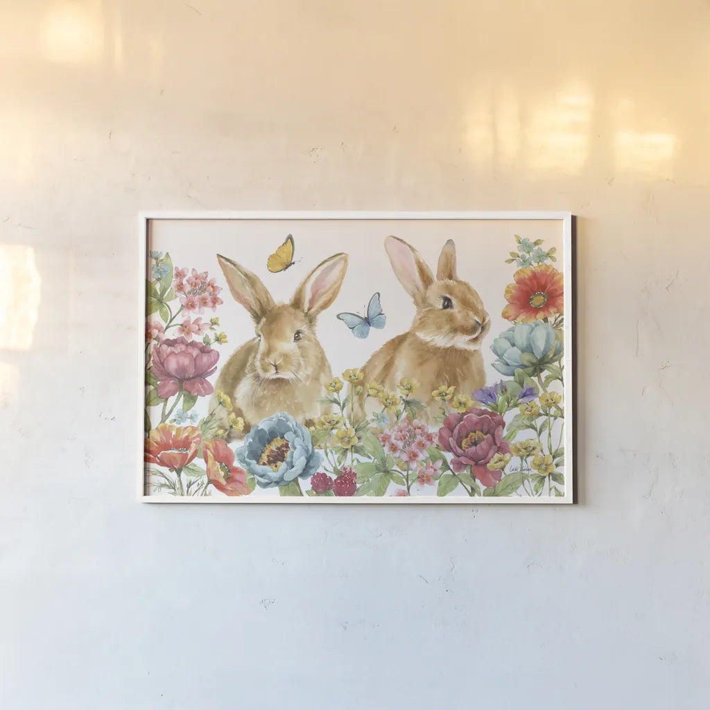 Garden Bunnies I by Leslie Trimbach. shown as a paper print in a white frame. Available as a archival giclee rolled canvas, fine art paper, or poster print. SKU 83601i.