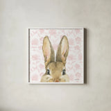 Garden Bunnies VI Pink by Leslie Trimbach. Shown in a crisp white glass frame for a clean and minimalist style. Available as an archival giclee rolled canvas, fine art paper, or poster print. SKU 84120a.
