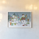 Snowman Family I by Leslie Trimbach. shown as a paper print in a white frame. Available as a archival giclee rolled canvas, fine art paper, or poster print. SKU 85253i.