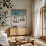 Snowman Family III by Leslie Trimbach. Shown in a natural wood frame in a cozy modern living room. Available as an archival giclee rolled canvas, fine art paper, or poster print. SKU 85255a.