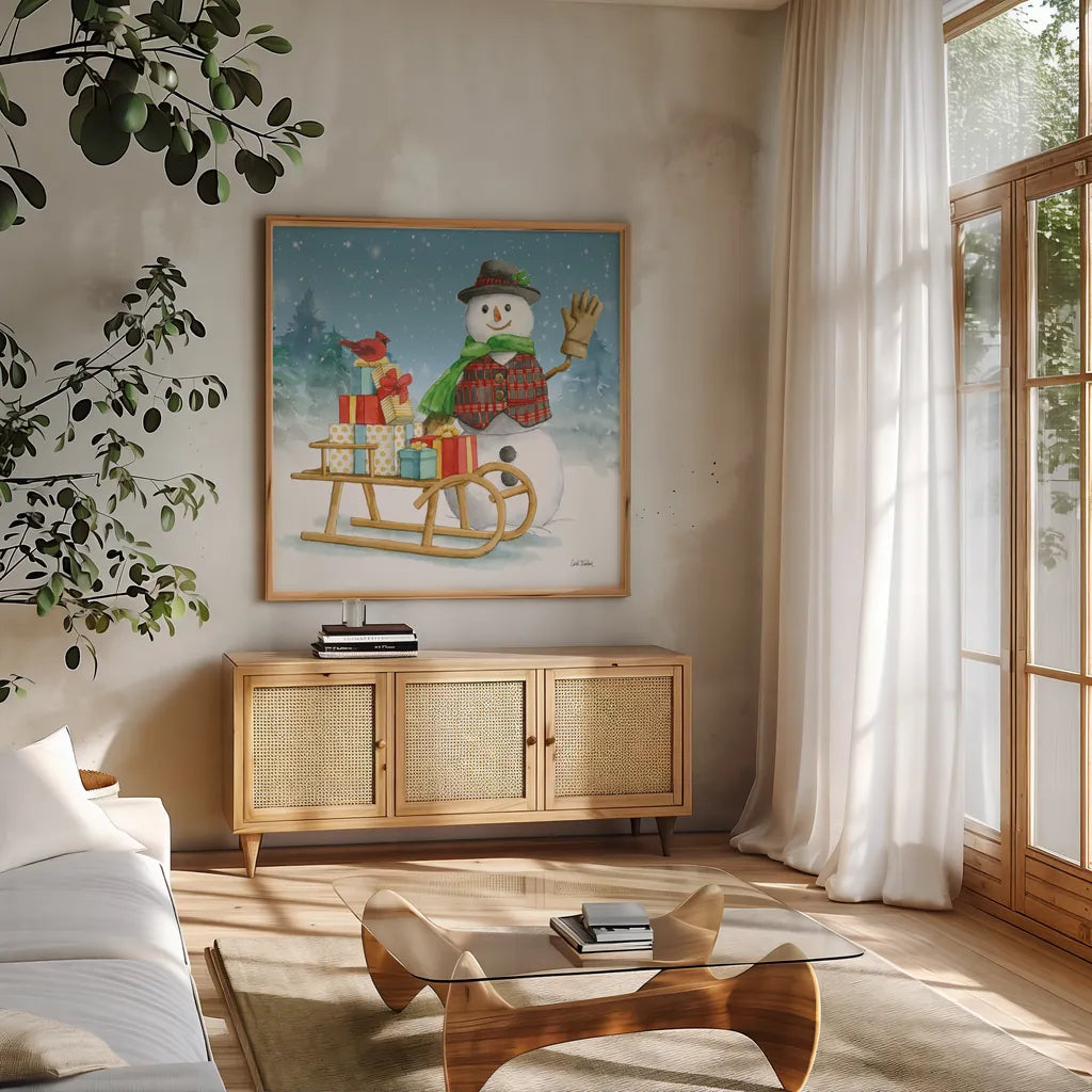 Snowman Family IV by Leslie Trimbach. Shown in a natural wood frame in a cozy modern living room. Available as an archival giclee rolled canvas, fine art paper, or poster print. SKU 85256a.