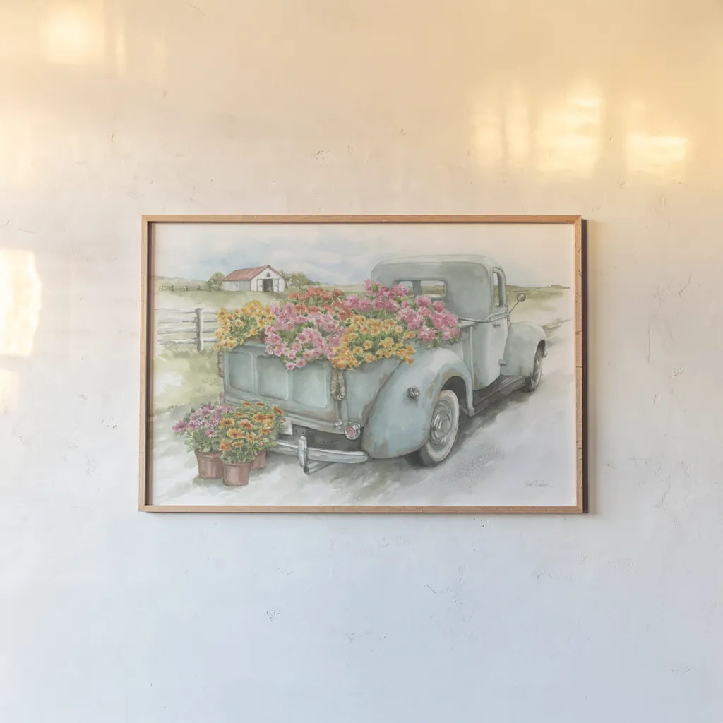 Truck with Flowers by Leslie Trimbach. shown as a paper print in a natural frame. Available as a archival giclee rolled canvas, fine art paper, or poster print. SKU 84630i.