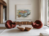 Truck with Flowers on Blue Sq by Leslie Trimbach. Shown as extra-large giant wall art in a modern living room. Available as an archival giclee rolled canvas, fine art paper, or poster print. SKU 86877a.