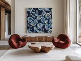 Indigold Flower Toss Indigo by Lisa Audit. Shown as extra-large giant wall art in a modern living room. Available as an archival giclee rolled canvas, fine art paper, or poster print. SKU 33664a.