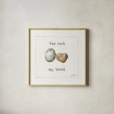 Pebbles and Sandpipers V by Lisa Audit. Shown in a natural wood glass frame for a timeless modern aesthetic. Available as an archival giclee rolled canvas, fine art paper, or poster print. SKU 17990a.