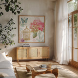 Rainbow Seeds Floral Birdcage II by Lisa Audit. Shown in a natural wood frame in a cozy modern living room. Available as an archival giclee rolled canvas, fine art paper, or poster print. SKU 23429a.