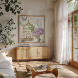 Rainbow Seeds Floral Birdcage II v2 by Lisa Audit. Shown in a natural wood frame in a cozy modern living room. Available as an archival giclee rolled canvas, fine art paper, or poster print. SKU 87449a.