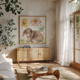 Spring Softies Bunnies III by Lisa Audit. Shown in a natural wood frame in a cozy modern living room. Available as an archival giclee rolled canvas, fine art paper, or poster print. SKU 25954a.