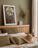 White Poppy by Mackenzie Nelson. shown as a paper print in a natural frame. Available as a archival giclee rolled canvas, fine art paper, or poster print. SKU 102204h.