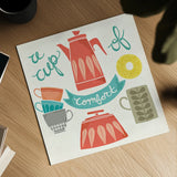 A Cup of Comfort by Mary Urban. Shown as a detailed flat fine art print, highlighting archival giclee quality. Available as an archival giclee rolled canvas, fine art paper, or poster print. SKU 25574a.