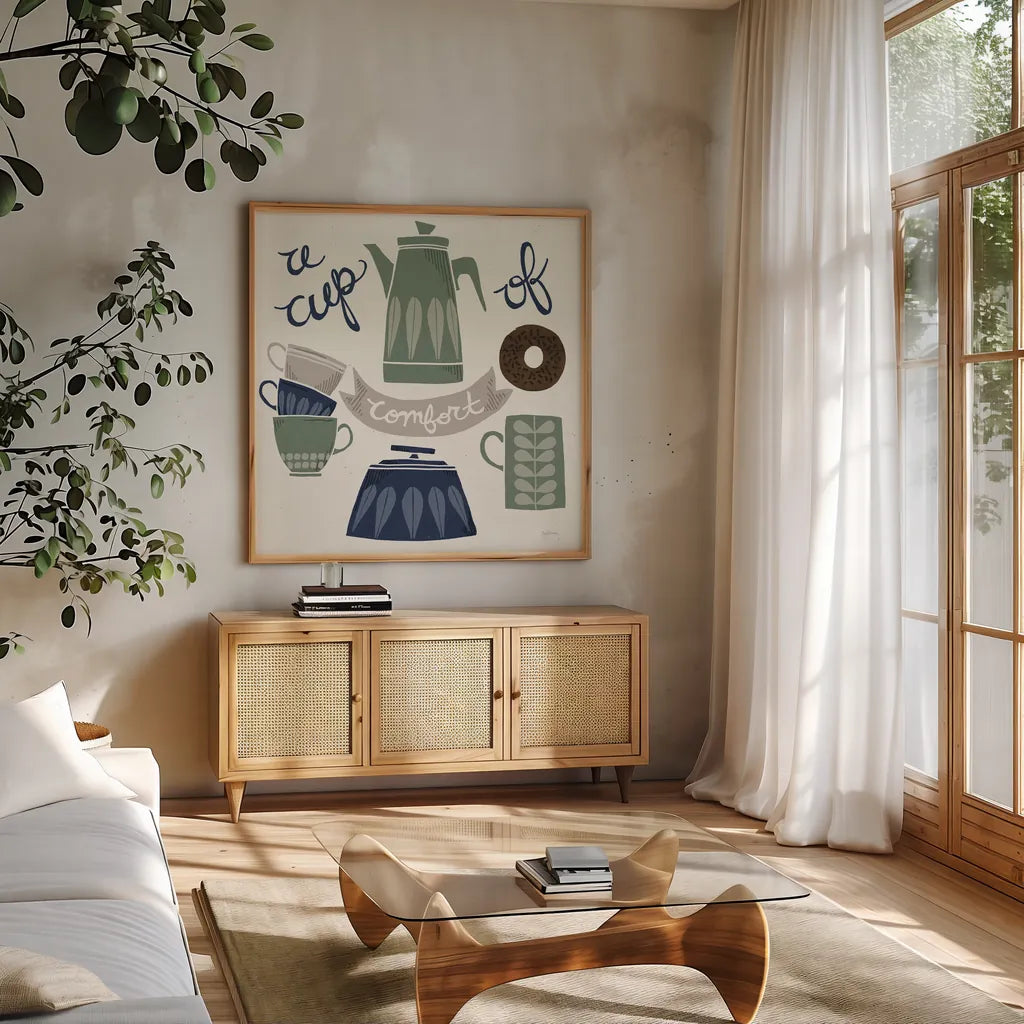 A Cup of Comfort Winter by Mary Urban. Shown in a natural wood frame in a cozy modern living room. Available as an archival giclee rolled canvas, fine art paper, or poster print. SKU 62316a.