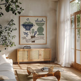 A Dash of Kindness Winter by Mary Urban. Shown in a natural wood frame in a cozy modern living room. Available as an archival giclee rolled canvas, fine art paper, or poster print. SKU 62317a.