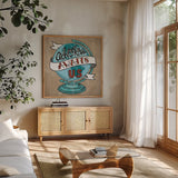 Adventure Love Globe Taupe by Mary Urban. Shown in a natural wood frame in a cozy modern living room. Available as an archival giclee rolled canvas, fine art paper, or poster print. SKU 20853a.