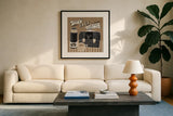 Lets Do Coffee Taupe by Mary Urban. Displayed in a glass frame with matte in a clean modern living room. Available as an archival giclee rolled canvas, fine art paper, or poster print. SKU 36498a.