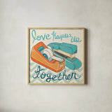 Love Keeps Us Together Orange by Mary Urban. Shown in a natural wood glass frame for a timeless modern aesthetic. Available as an archival giclee rolled canvas, fine art paper, or poster print. SKU 30512a.