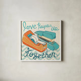 Love Keeps Us Together Orange by Mary Urban. Shown in a crisp white glass frame for a clean and minimalist style. Available as an archival giclee rolled canvas, fine art paper, or poster print. SKU 30512a.