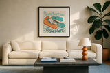 Love Keeps Us Together Orange by Mary Urban. Displayed in a glass frame with matte in a clean modern living room. Available as an archival giclee rolled canvas, fine art paper, or poster print. SKU 30512a.