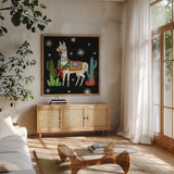 Lovely Llamas V Christmas Black by Mary Urban. Shown in a natural wood frame in a cozy modern living room. Available as an archival giclee rolled canvas, fine art paper, or poster print. SKU 43979a.