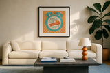 The Snooze Button Orange by Mary Urban. Displayed in a glass frame with matte in a clean modern living room. Available as an archival giclee rolled canvas, fine art paper, or poster print. SKU 20979a.