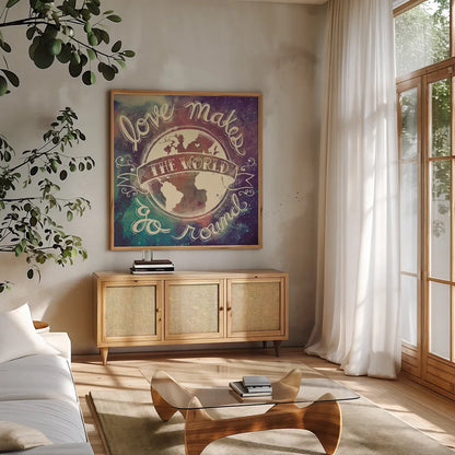 Universe Galaxy Love Makes by Mary Urban. Shown in a natural wood frame in a cozy modern living room. Available as an archival giclee rolled canvas, fine art paper, or poster print. SKU 18444a.