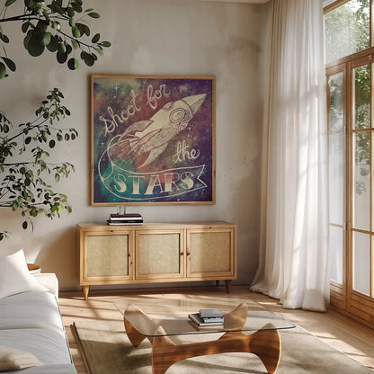 Universe Galaxy Shoot for the Stars by Mary Urban. Shown in a natural wood frame in a cozy modern living room. Available as an archival giclee rolled canvas, fine art paper, or poster print. SKU 18445a.