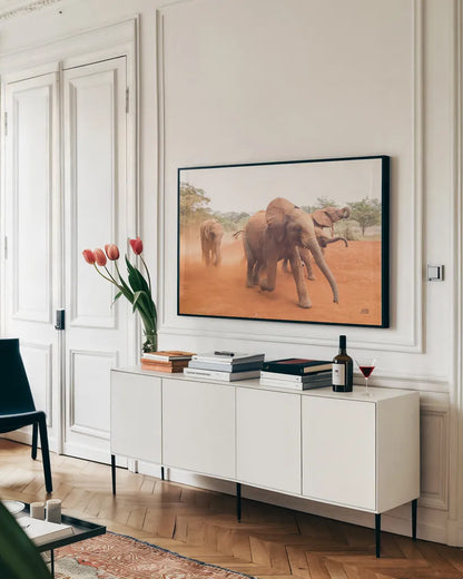 Elephant Race by Max Blakesberg Studios. shown as a framed stretched canvas in a living room above a console. Available as a archival giclee rolled canvas, fine art paper, or poster print. SKU 93614i.