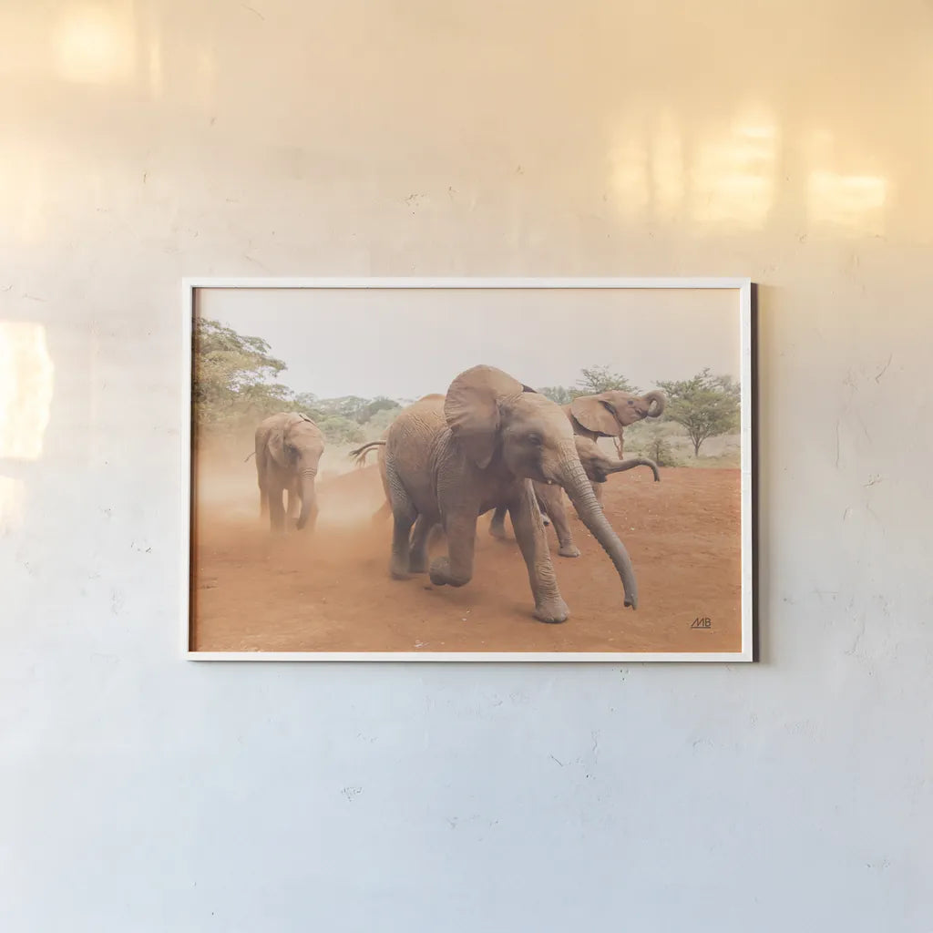 Elephant Race by Max Blakesberg Studios. shown as a paper print in a white frame. Available as a archival giclee rolled canvas, fine art paper, or poster print. SKU 93614i.
