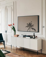 Evening Palm Sepia by Max Blakesberg Studios. shown as a framed stretched canvas in a living room above a console. Available as a archival giclee rolled canvas, fine art paper, or poster print. SKU 103355i.