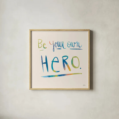 Be Your Own Hero Colorful by Melissa Averinos. Shown in a natural wood glass frame for a timeless modern aesthetic. Available as an archival giclee rolled canvas, fine art paper, or poster print. SKU 77929a.