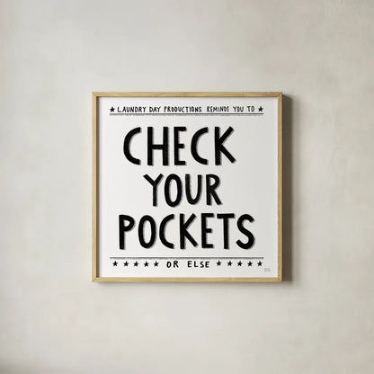 Check Your Pockets by Melissa Averinos. Shown in a natural wood glass frame for a timeless modern aesthetic. Available as an archival giclee rolled canvas, fine art paper, or poster print. SKU 59179a.