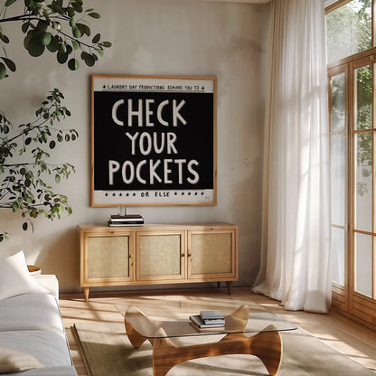 Check Your Pockets by Melissa Averinos. Shown in a natural wood frame in a cozy modern living room. Available as an archival giclee rolled canvas, fine art paper, or poster print. SKU 59465a.