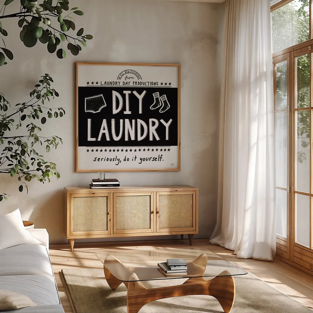 DIY Laundry BW by Melissa Averinos. Shown in a natural wood frame in a cozy modern living room. Available as an archival giclee rolled canvas, fine art paper, or poster print. SKU 59466a.