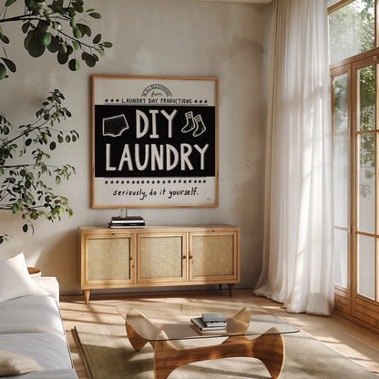 DIY Laundry BW by Melissa Averinos. Shown in a natural wood frame in a cozy modern living room. Available as an archival giclee rolled canvas, fine art paper, or poster print. SKU 59466a.
