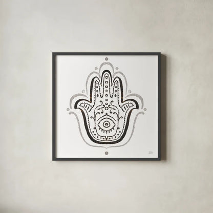 Hamsa Amulet in Black by Melissa Averinos. Shown in a sleek black glass frame for a contemporary gallery look. Available as an archival giclee rolled canvas, fine art paper, or poster print. SKU 64429a.