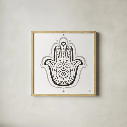 Hamsa Amulet in Black by Melissa Averinos. Shown in a natural wood glass frame for a timeless modern aesthetic. Available as an archival giclee rolled canvas, fine art paper, or poster print. SKU 64429a.