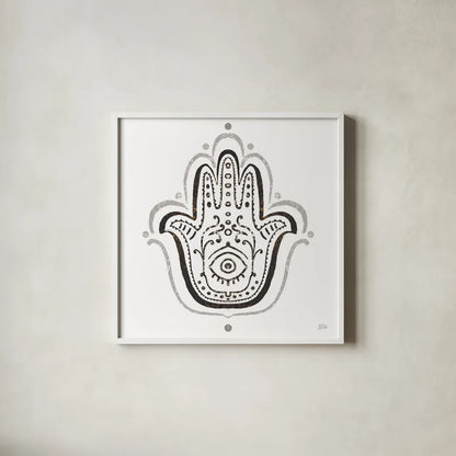 Hamsa Amulet in Black by Melissa Averinos. Shown in a crisp white glass frame for a clean and minimalist style. Available as an archival giclee rolled canvas, fine art paper, or poster print. SKU 64429a.