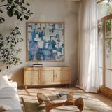 In Blue A Maze by Melissa Averinos. Shown in a natural wood frame in a cozy modern living room. Available as an archival giclee rolled canvas, fine art paper, or poster print. SKU 27613a.