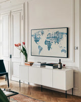 Kanari Map Indigo by Melissa Averinos. shown as a framed stretched canvas in a living room above a console. Available as a archival giclee rolled canvas, fine art paper, or poster print. SKU 43216i.
