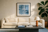 Kanari Square II Indigo by Melissa Averinos. Displayed in a glass frame with matte in a clean modern living room. Available as an archival giclee rolled canvas, fine art paper, or poster print. SKU 43112a.