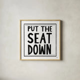 Put the Seat Down by Melissa Averinos. Shown in a natural wood glass frame for a timeless modern aesthetic. Available as an archival giclee rolled canvas, fine art paper, or poster print. SKU 59180a.