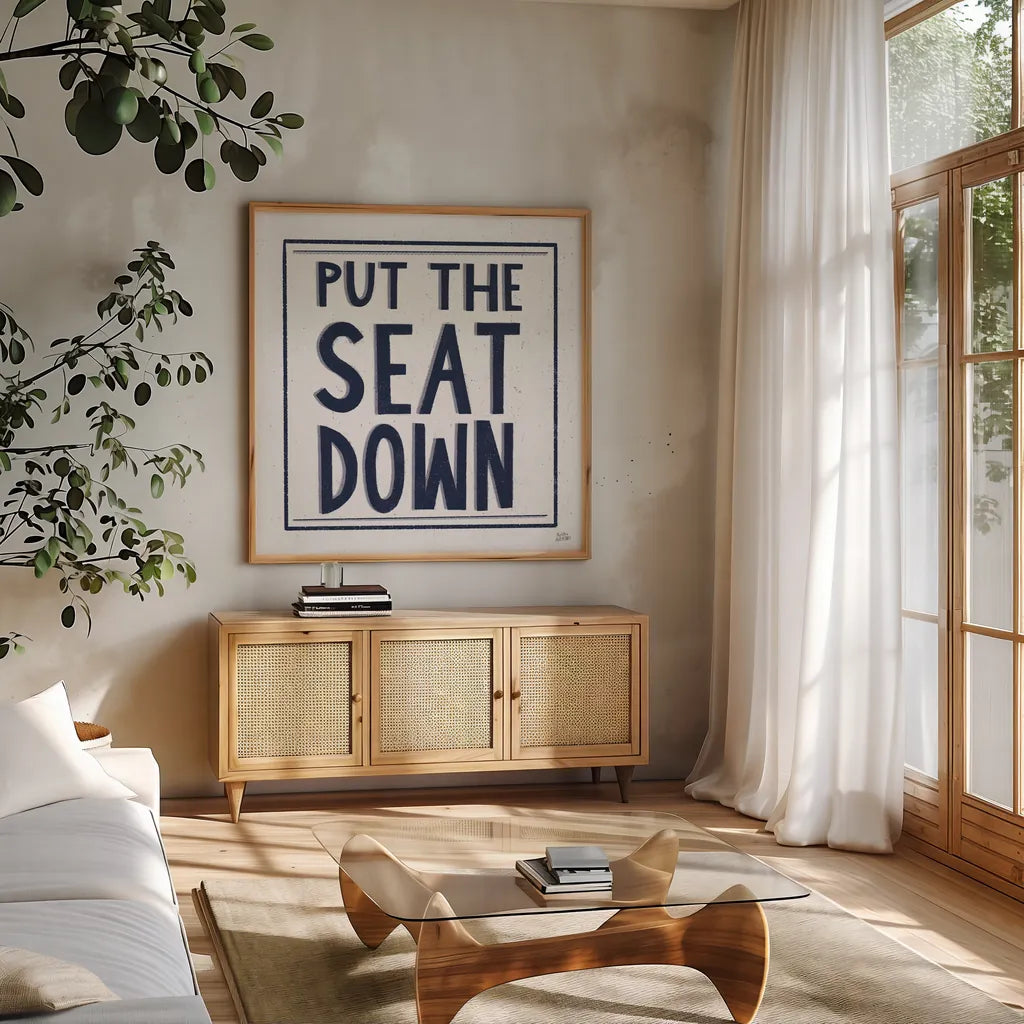 Put the Seat Down Navy by Melissa Averinos. Shown in a natural wood frame in a cozy modern living room. Available as an archival giclee rolled canvas, fine art paper, or poster print. SKU 59464a.