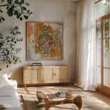 Saffron Mandala II Crop by Melissa Averinos. Shown in a natural wood frame in a cozy modern living room. Available as an archival giclee rolled canvas, fine art paper, or poster print. SKU 29694a.