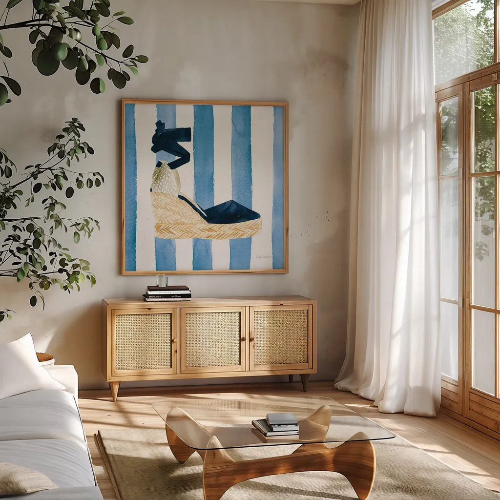 Beach Glam VI Navy on Stripes by Mercedes Lopez Charro. Shown in a natural wood frame in a cozy modern living room. Available as an archival giclee rolled canvas, fine art paper, or poster print. SKU 71995a.